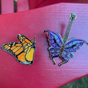 Two butterfly enamel pins